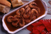 a dish of Barbecued Shrimp sitting in gravy