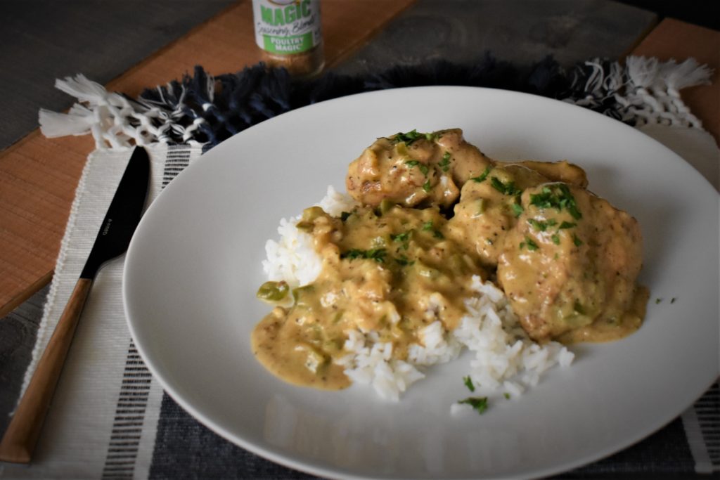 a plate with cheese and hot pepper chicken with a side of rice