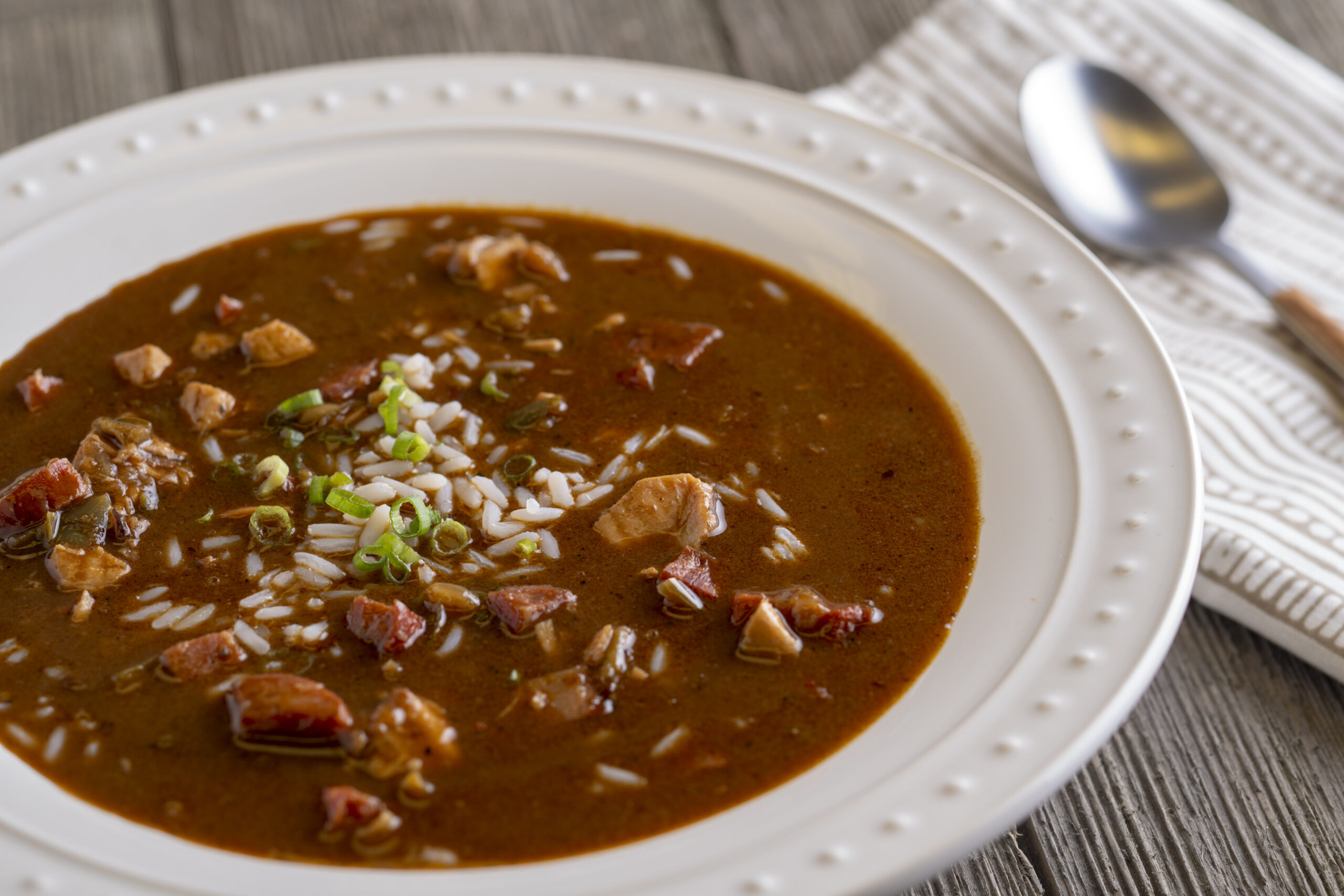 a plate of chicken and andouille smoked sauasage gumbo with rice