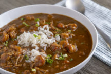 a bowl of shrimp or crawfish etouffee, also known as a stew, with rice