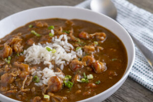 a bowl of shrimp or crawfish etouffee, also known as a stew, with rice