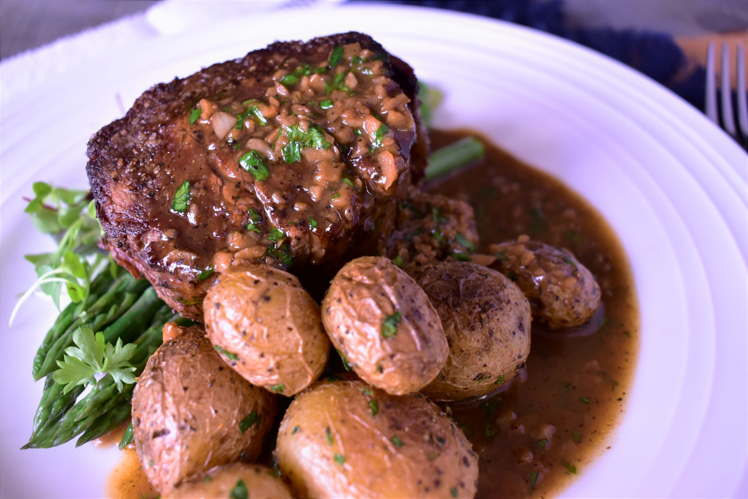 a plate of filet with browned garlic butter sauce