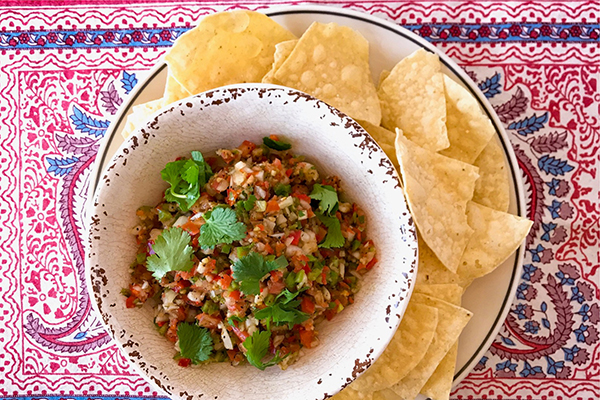 a plate of pic de gallo on a plate of chips