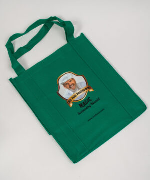 green shopping bag with chef paul's logo face on it