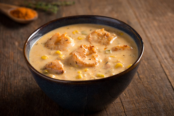 a small bowl of shrimp and corn soup