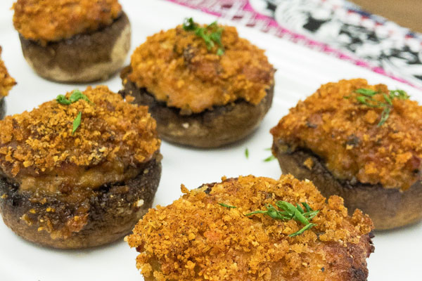 a plate full of shrimp and sausage stuffed mushrooms