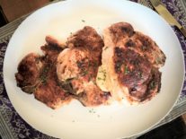 a plate of 3, four cheese stuffed pork chops