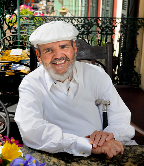 Chef Paul Prudhomme posing at a table