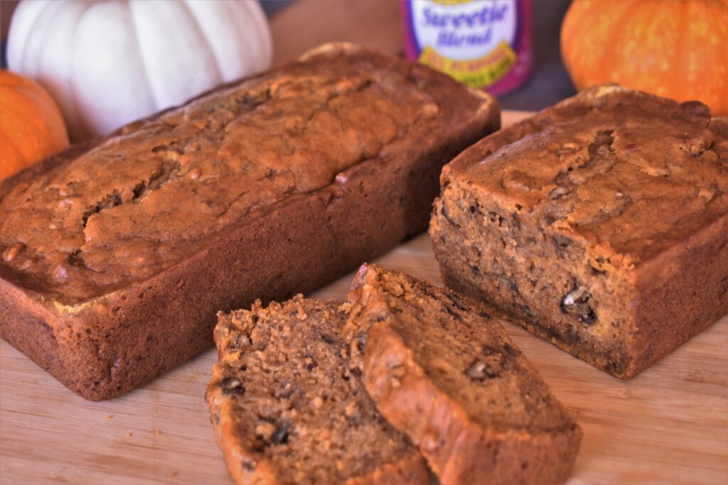 a loaf of banana and pumpkin spice bread next to pieces of the bread