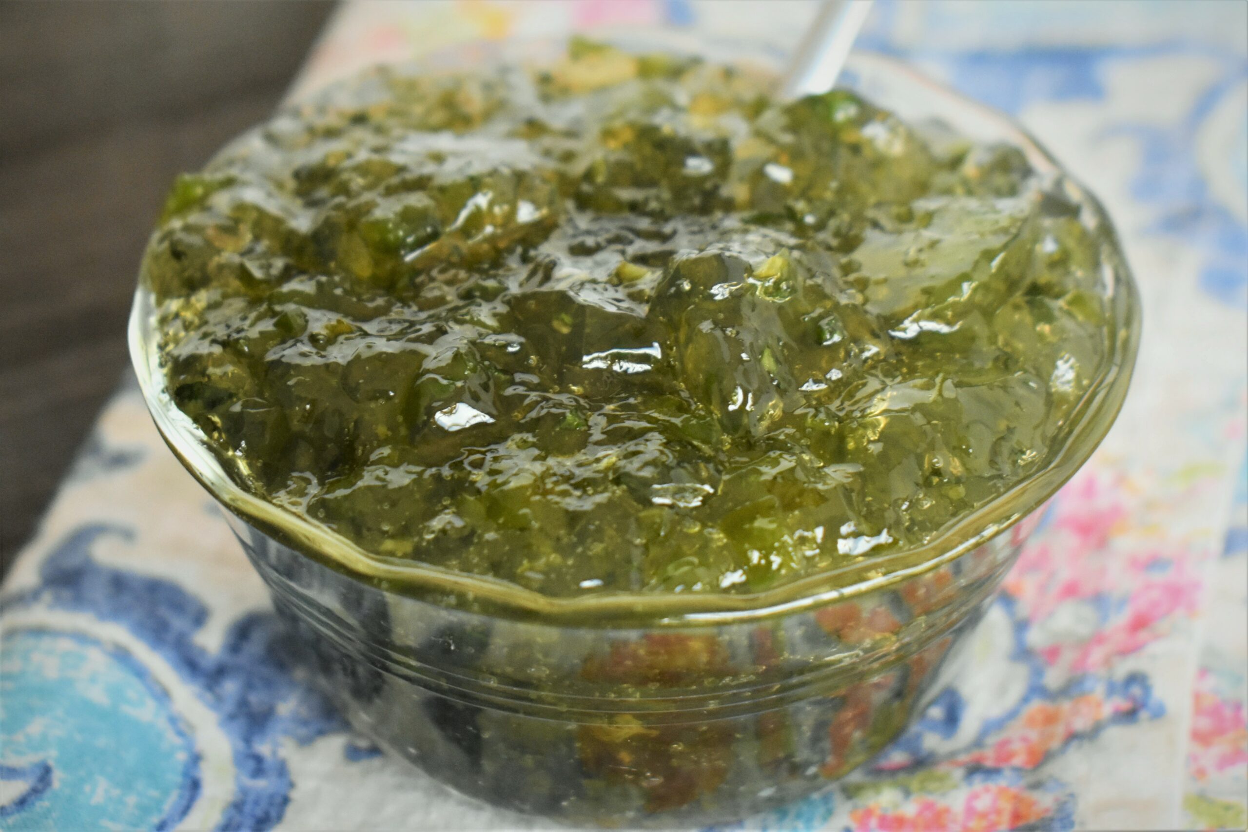 a close up of a cup of jalapeno mint jelly