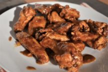 a close up of a plate full of bone in caribbean jerk wings