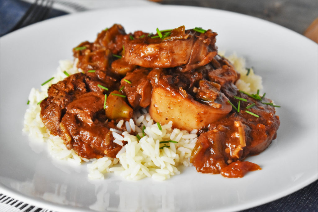 a plate with Veal Shanks with okra and tomato