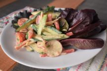 a plate with cucumber salad with lemon dill dressing