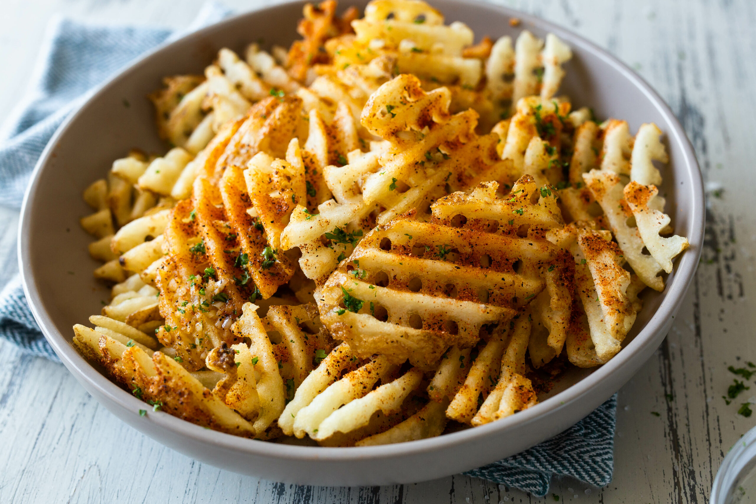 a plate of garlic waffle fries