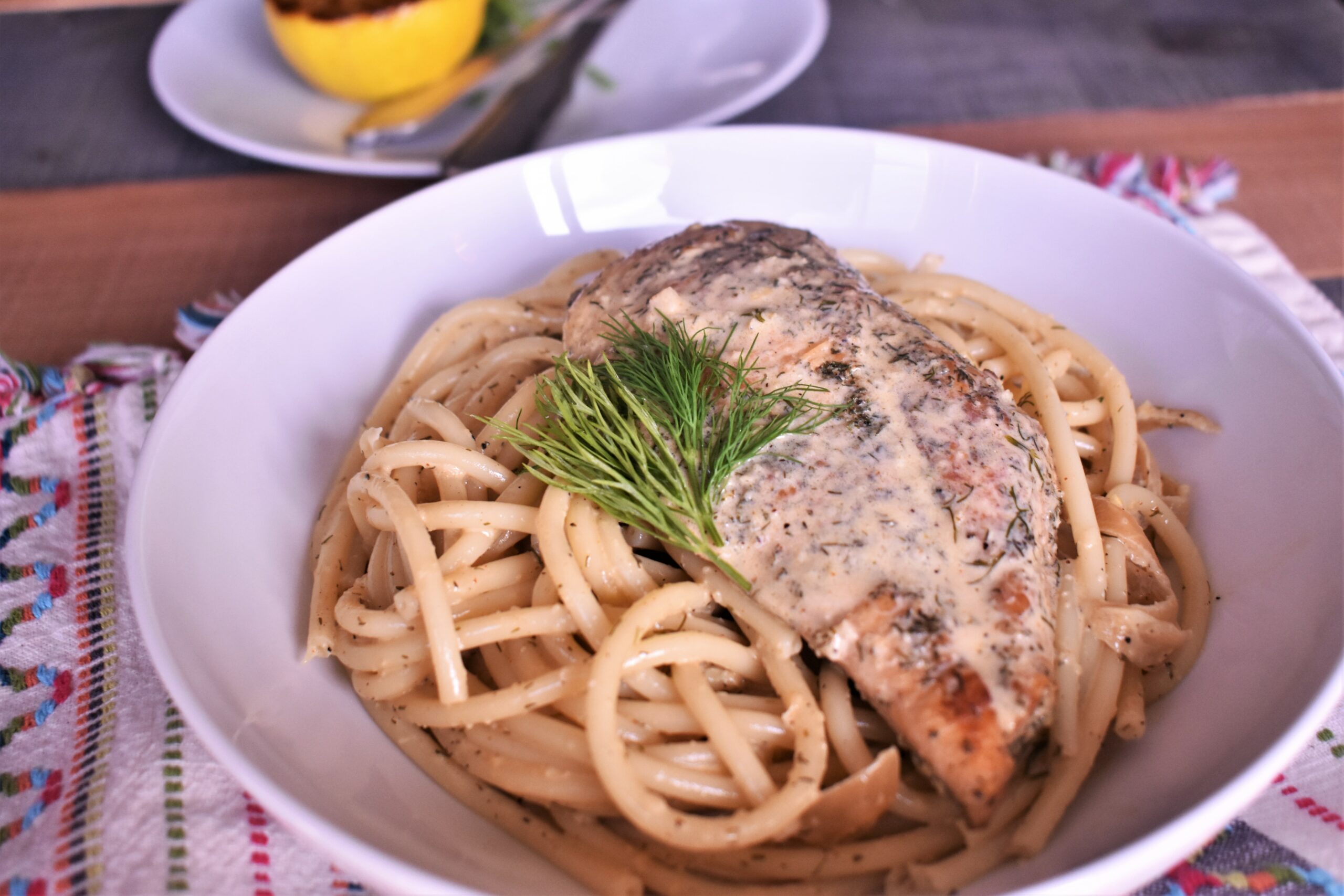 a plate of creamy lemon dill chicken with noodles