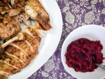 a close up of a plate of fresh cranberry chutney and a plate of turkey meat