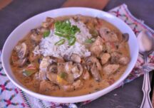 a bowl of turkey rex with rice and green onions on top