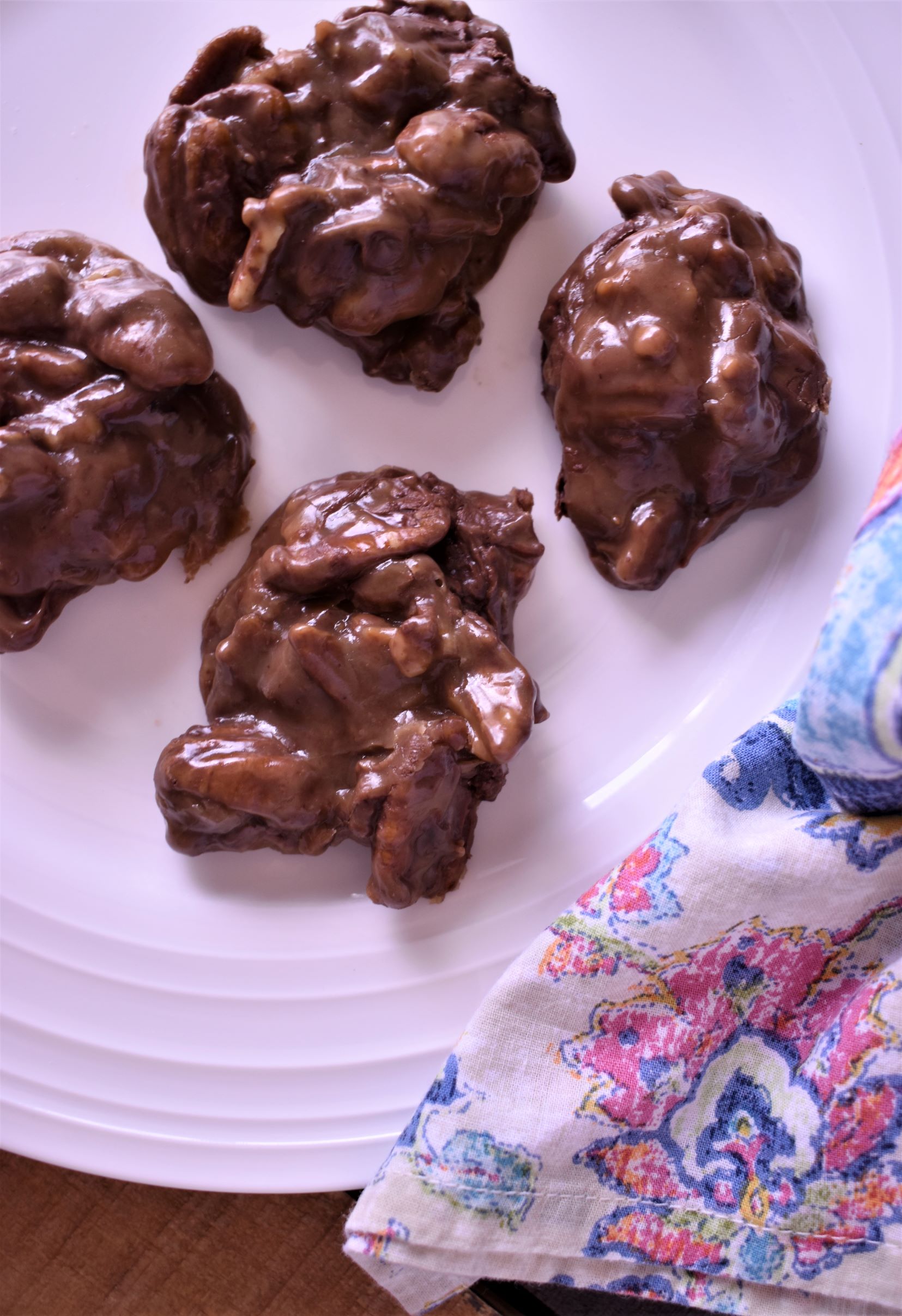 4 chocolate pecan pralines on a plate