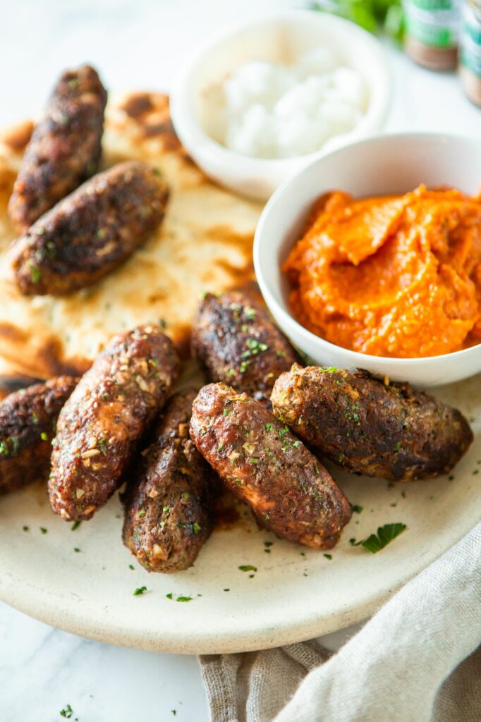 a plate full of macedonian kebapi and ajvar