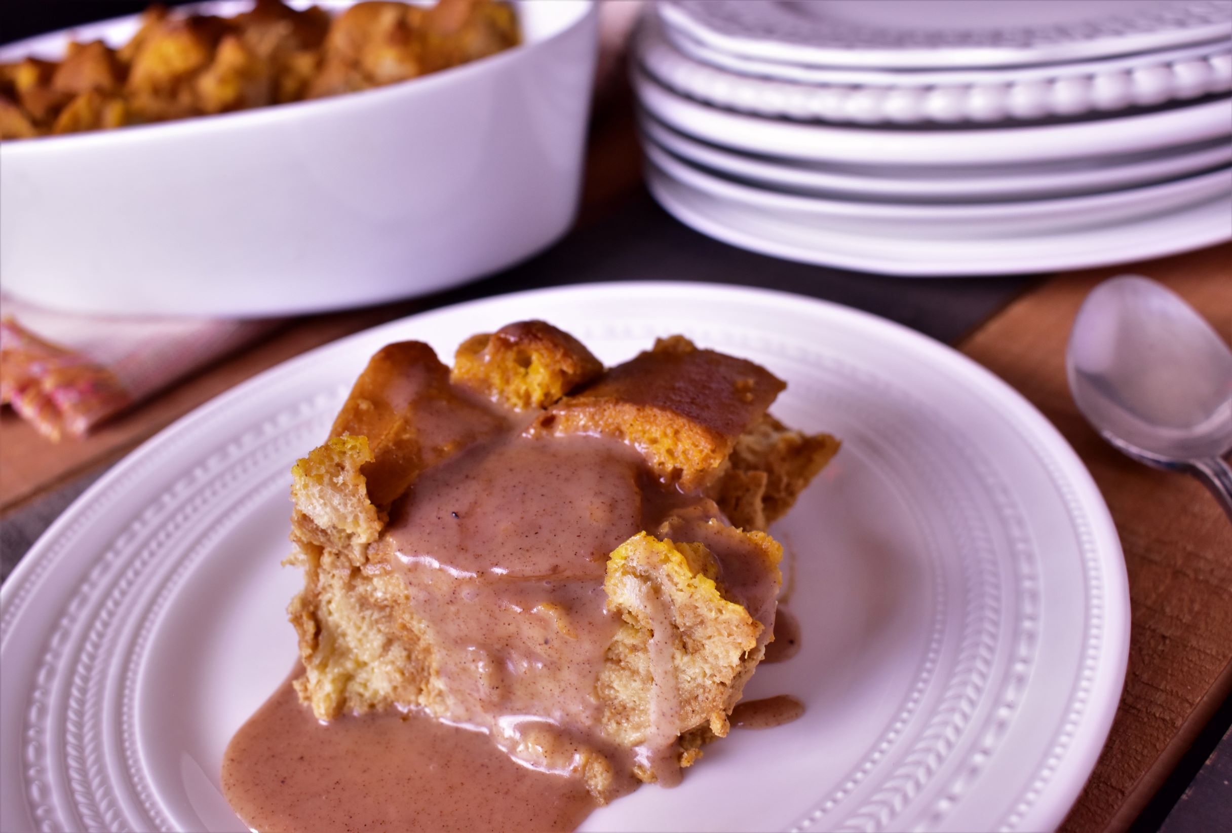 a piece of pumpkin bread pudding with sauce all over it