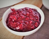 a close up of a bowl of caramelized onion and red wine cranberry sauce