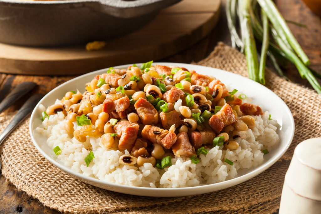 blackeyed peas in a white dish on a brown cloth on top a table