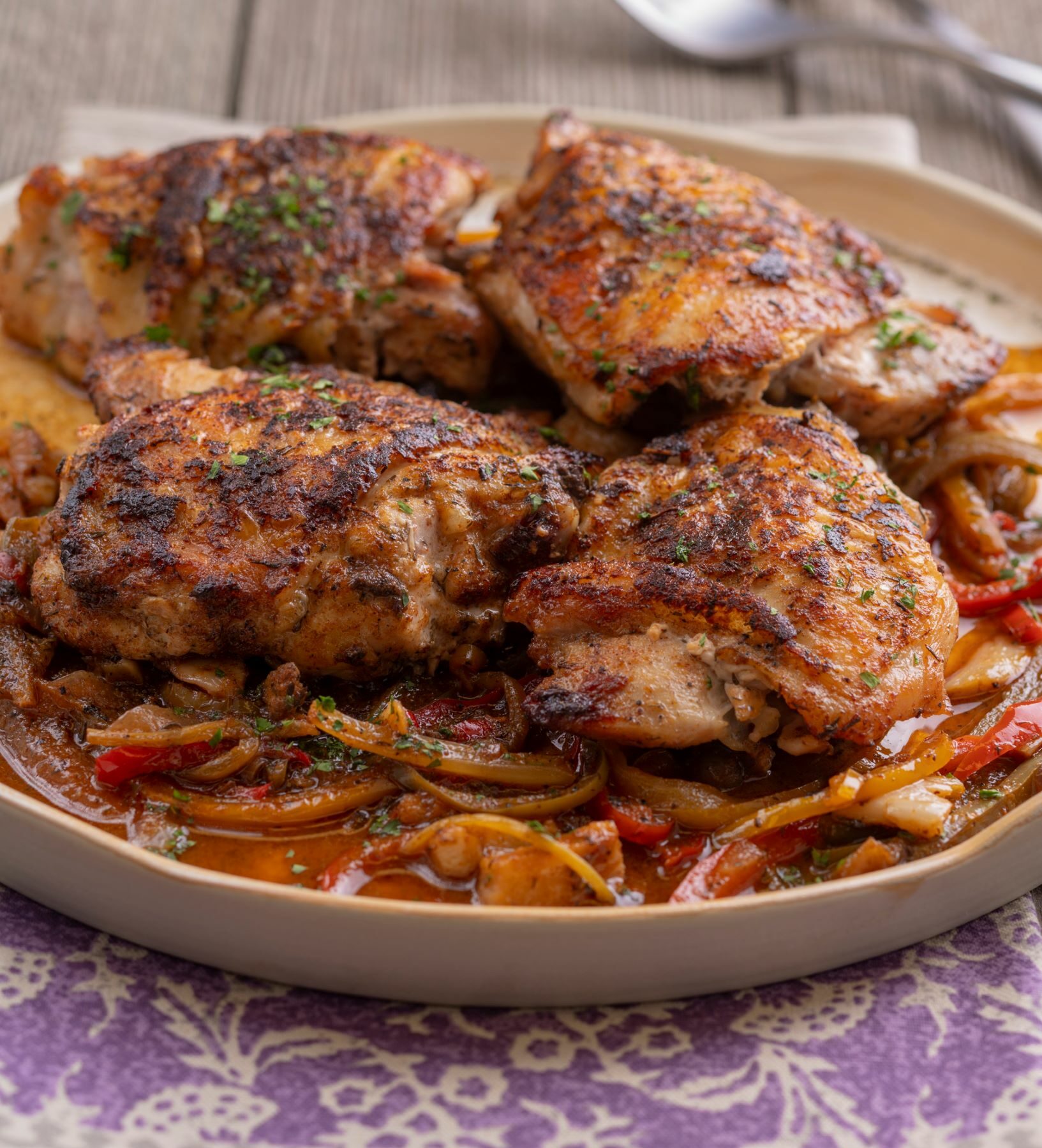 a plate full of sweet and spicy braised chicken thighs cooked with salt free sugar free magic seasoning blends