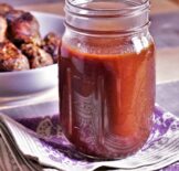 a mason jar full of sweet and tangy bbq sauce