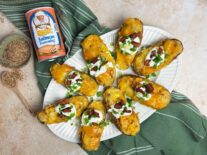 twice baked potatoes topped with cheese, a dallop of sour cream and green onions