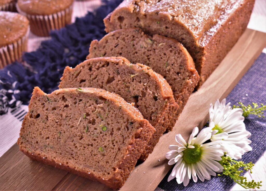 a loaf of zucchini bread with 3 pieces cut out of it