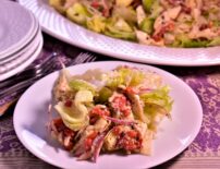 a plate of st louis styled italian salad next to a platter of more salad