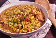 a bowl of creamed corn with andouille