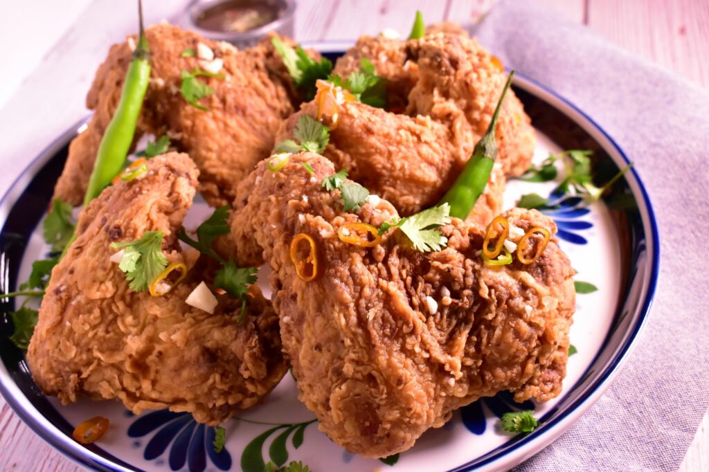 a plate of thai chili lime wings dressed with basil as a garnish