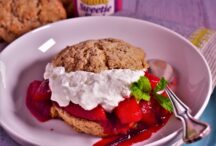 a plate of plum shortcake with plum juice seaping out the cake