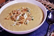 a bowl of green curry, crab and corn bisque