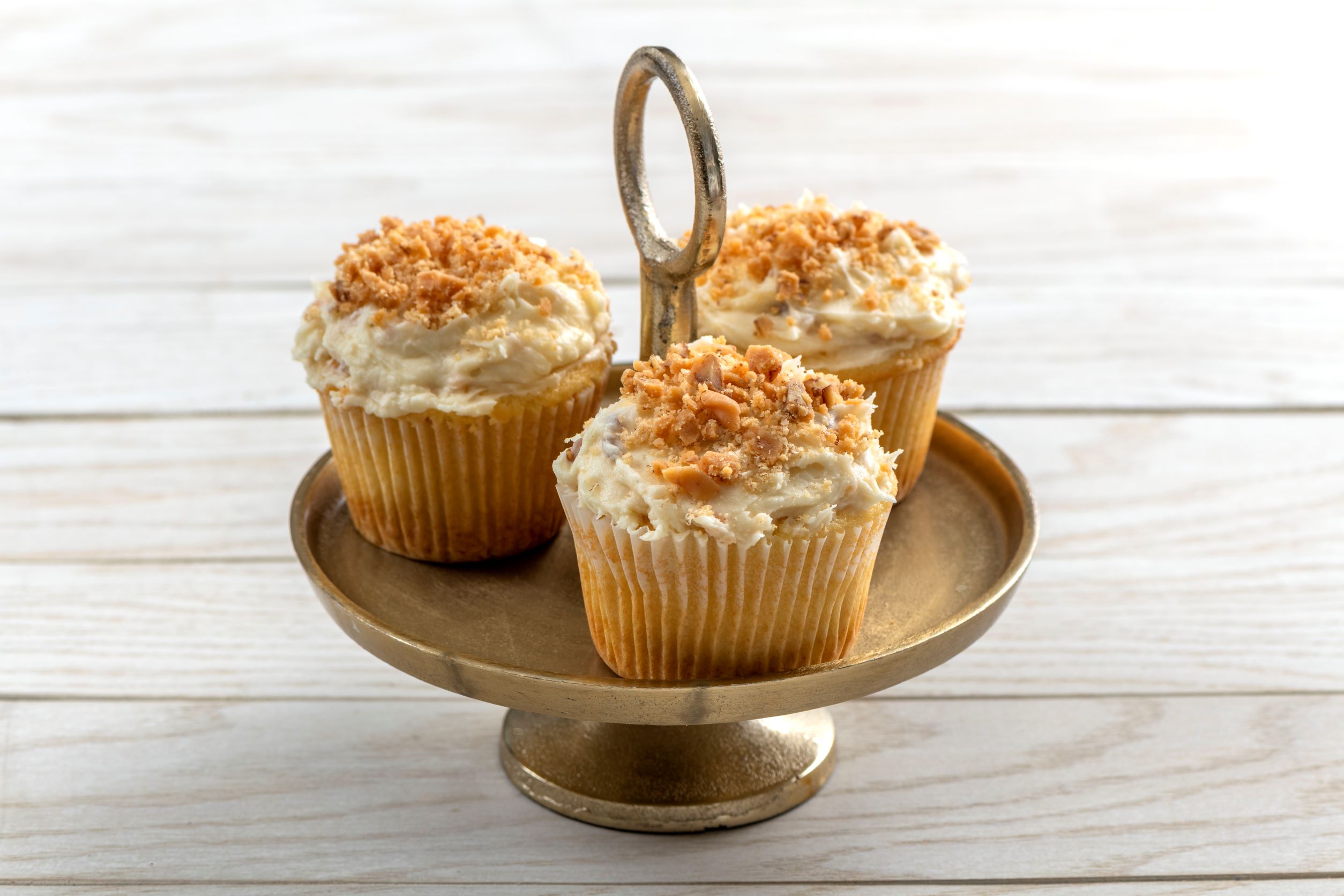 3 praline cupcakes on a decorative platter