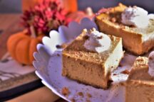 3 pieces of pumpkin cheesecake sqaure topped with a heavy cream