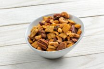 a bowl of assorted trail mix featuring pecans and cashews