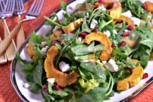 a plate of roasted delicata fall salad topped with roasted pineapples