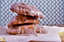 3 Pieces of air fryer apple fritters stacked on top of eachother, drizzled with frosting