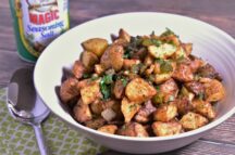 a bowl of OBrein potatoes cooked in an air fryer, next to a container of Magic seasoning salt