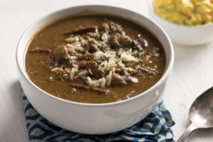 Close up of a white bowl filled with duck and oyster gumbo