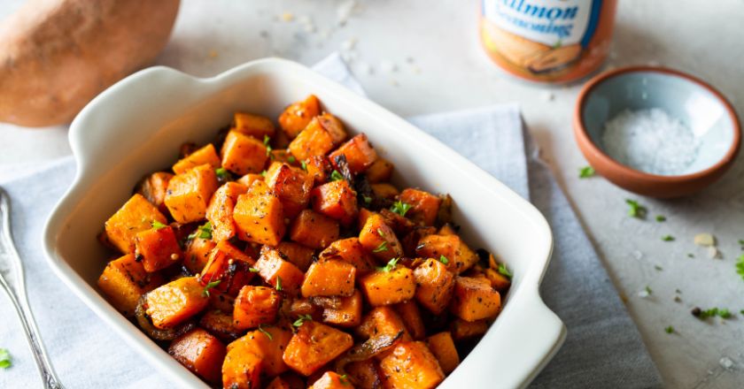 A white serving dish filled with sweet potatoes