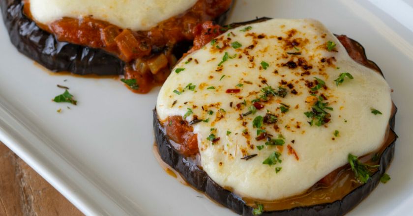 eggplant with cheese on top on a white plate