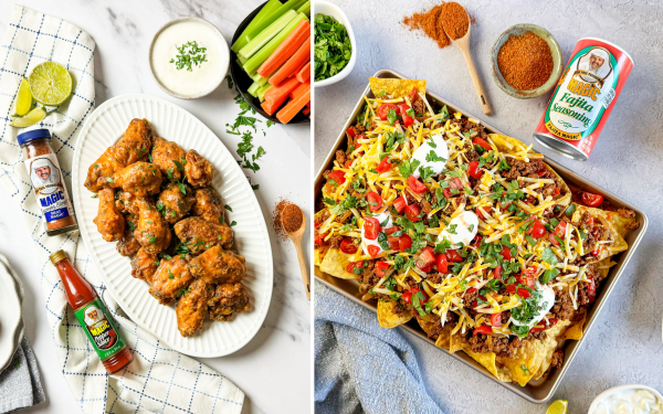Overhead view of two game-day dishes styled on a light surface: on the left, a platter of crispy, sauced chicken wings garnished with herbs, served with celery, carrots, and dipping sauce alongside Magic Seasoning Blends and hot sauce; on the right, a tray of loaded nachos topped with seasoned ground beef, melted cheese, tomatoes, cilantro, and sour cream, with Magic Fajita Seasoning nearby.