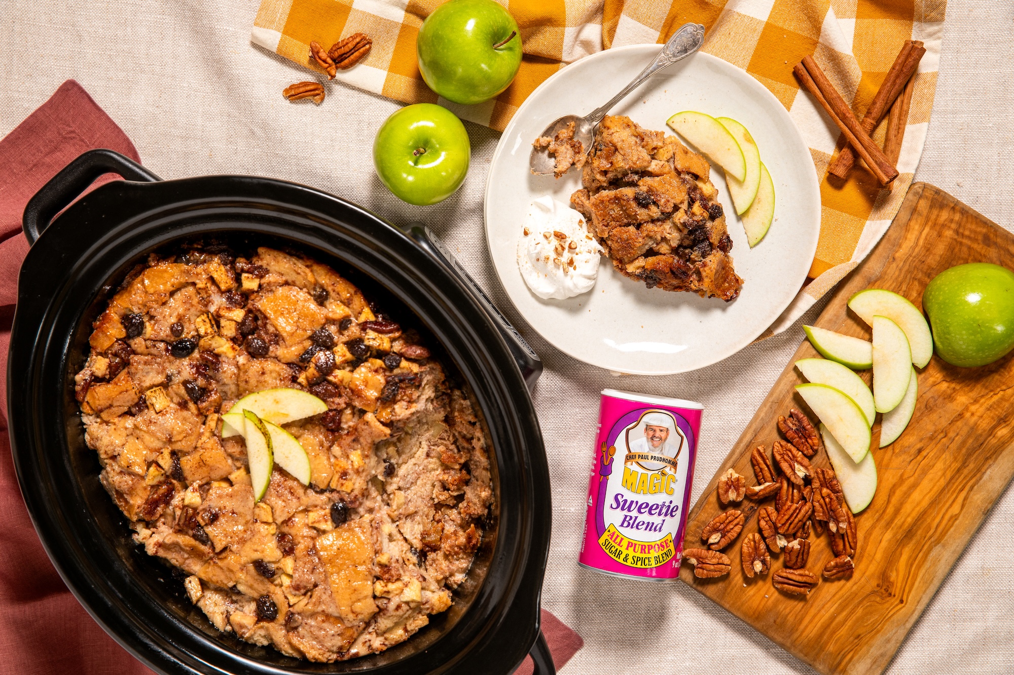 Slow Cooker Apple Bread Pudding in a crockpot with apples, pecans, and Sweetie Blend seasoning.