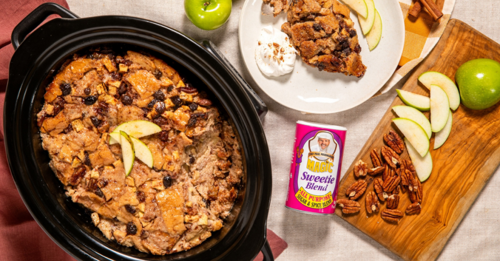 Slow cooker apple bread pudding with green apples, pecans, raisins, and Chef Paul Prudhomme’s Magic Sweetie Blend, served with whipped cream.