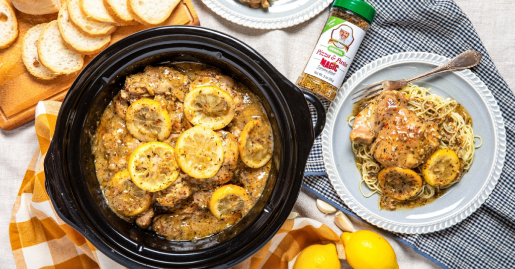 Slow cooker lemon garlic butter chicken with sliced lemons, served over pasta with Chef Paul Prudhomme’s Pizza & Pasta Magic seasoning.